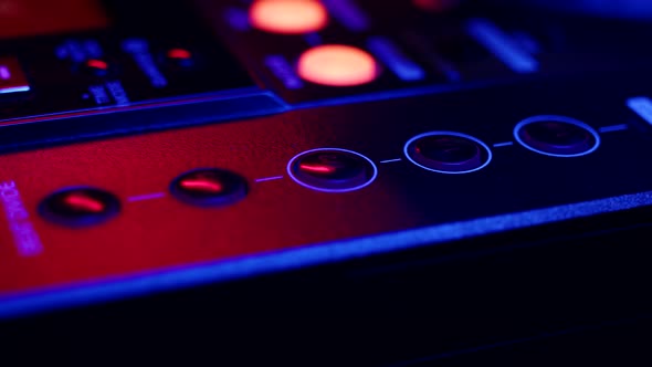 DJ Hand Switches Channels on Mixing Console Pressed Buttons Closeup