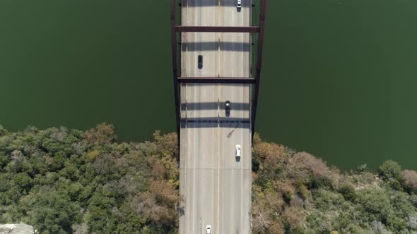 Aerial view of cars driving over the The Percy V. Pennybacker Jr. Bridge in Austin, Texas. This vide