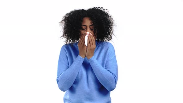 African Woman Sneezes Into Tissue