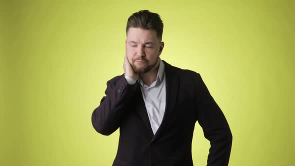 Bearded Man in Suit Scratching Back of His Head and Thinking Finds a Solution