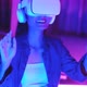 Young asian woman is using virtual reality headset. Neon light studio portrai - VideoHive Item for Sale