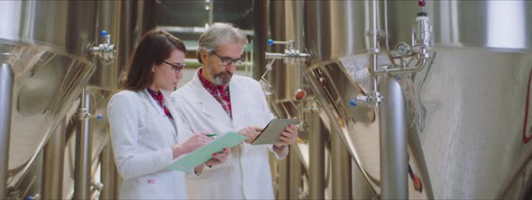 Research associates checking brewing vat