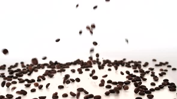 Coffee Beans Falling on White Floor Slow motion