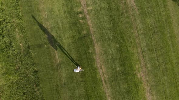 High view of a male walking on a golf field