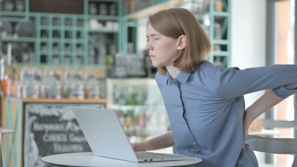 Young Woman Having Back Pain While Using Laptop