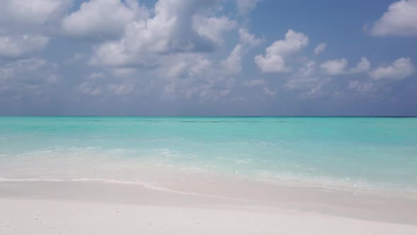 Aerial drone panorama of tranquil island beach adventure by shallow lagoon with white sandy backgrou