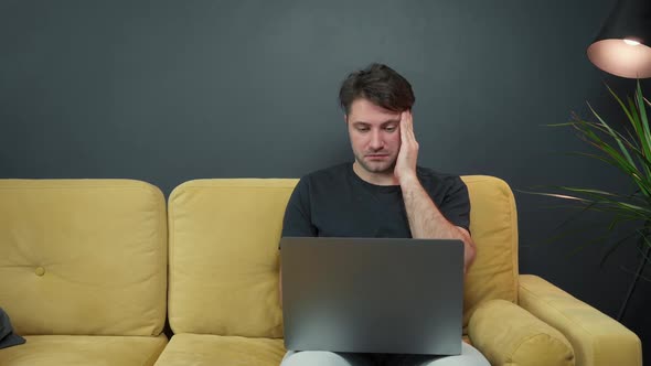 Unshaven Handsome Guy Shaking Legs Nervously Suffering From Fatigue or Headache