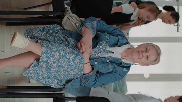 Vertical Video Portrait of Senior Patient Sitting in Waiting Room Area