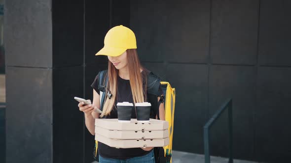 Close Up of Young Woman Delivery Worker Standing at Street and Holding Carton