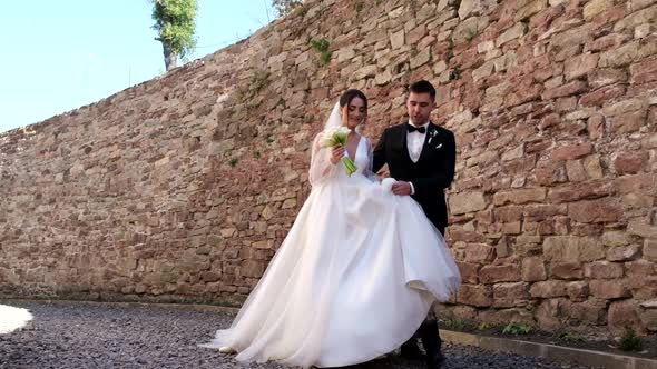 The Groom Helps to Carry the Dress to His Wife