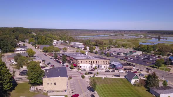 Panning aerial of buildings and street traffic in Montague, Michigan