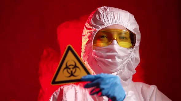 Medical Lab Worker with Protective Gloves Showing Stop Sign on Hospital 