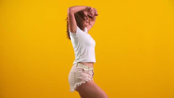 Girl Dancing on a Yellow Background