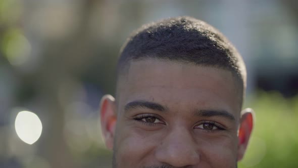 Closeup of Young Male Eyes in Park Looking at Camera, Smiling