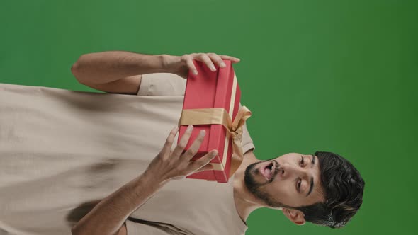 Vertical View Portrait Friendly Indian Arab Man Guy Receive Surprise Red Box From Unknown Person