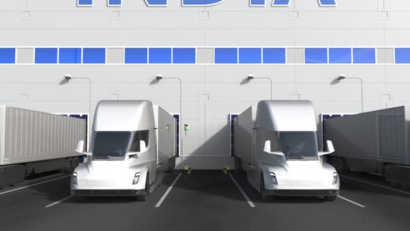 Electric Trucks at Warehouse Dock with PRODUCT OF INDIA Text alt