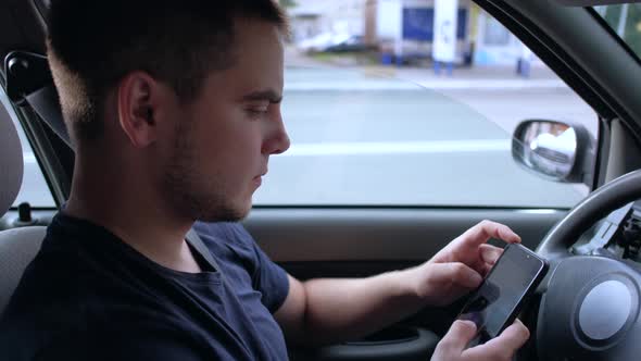 Guy Use Smartphone in Car