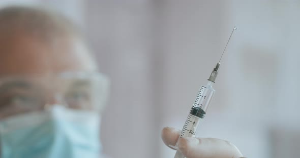 Medic Hands Preparing a Syringe with Antibiotic for Intravenous Treatment. A Syringe with a Medicine