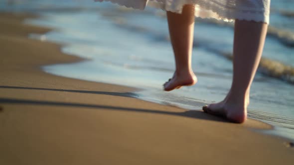 Pretty Woman Walks at Seaside Surf