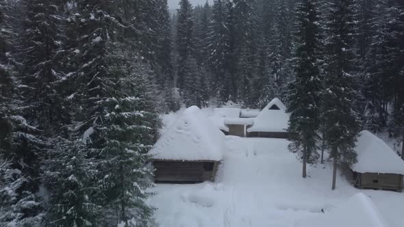 Flying Over Wooden Houses in Winter