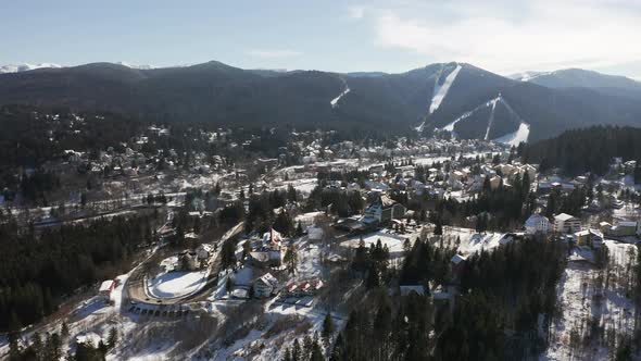 Aerial view over town of Predeal, Romania; Clabucet Mountains in distance.