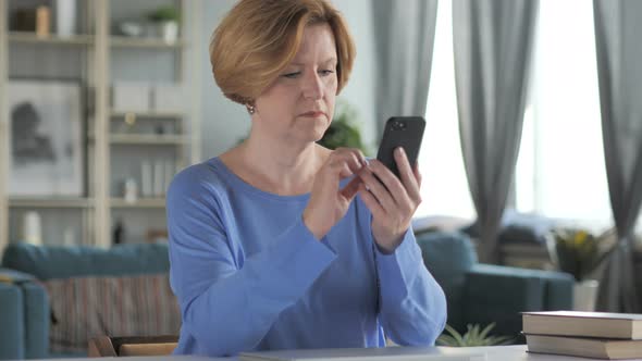 Old Senior Woman Text Messaging on Smartphone