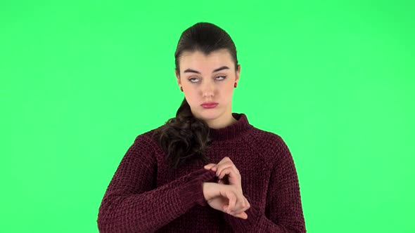 Young Woman Stands Waiting with Boredom on Green Screen.