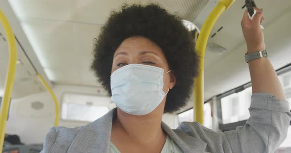 Plus size biracial woman wearing face mask in bus