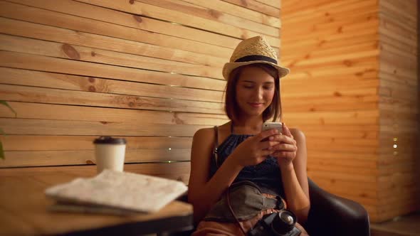 Beautiful Brunette Girl Smiling Looking at Phone Sitting in Cafe Slow Motion