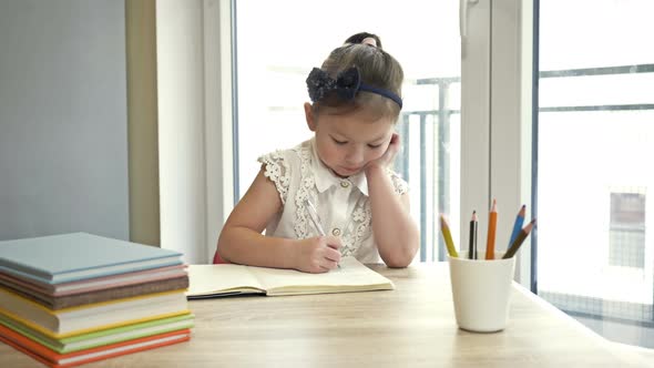 Little Elementary Schoolgirl Doing Homework