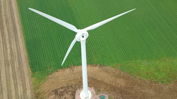 Slow tilting reveal of wind turbine in British countryside