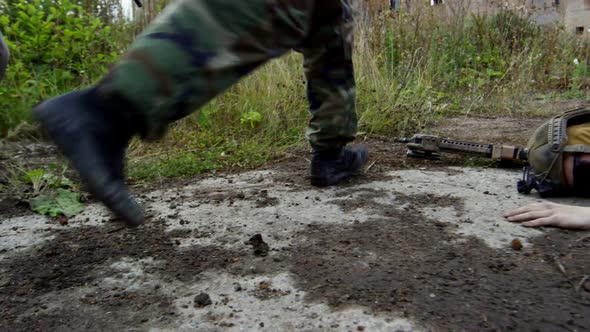 Soldiers Running by Killed Teammate