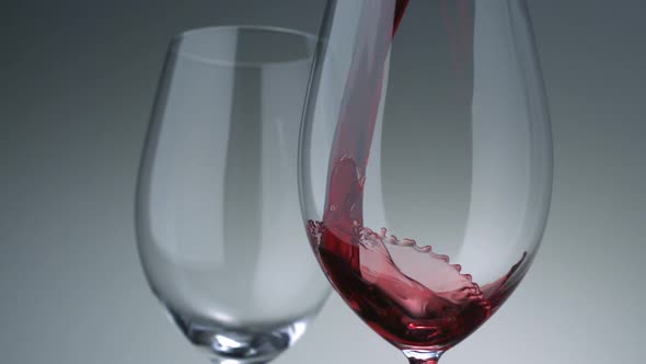 Pouring red wine into glass, Slow Motion