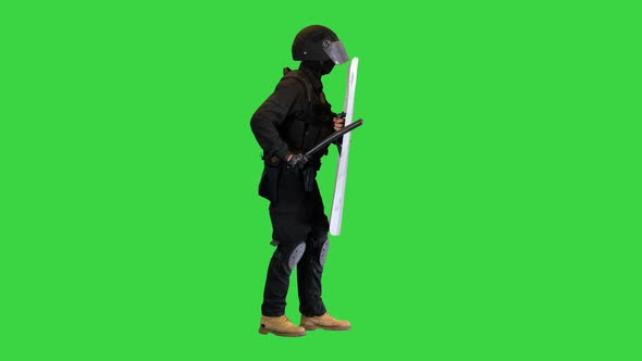 Riot Police Making Noise Hitting His Riot Shield with Baton on a Green Screen Chroma Key