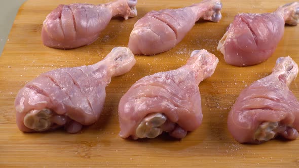 The process of pickling chicken legs on a cutting  board