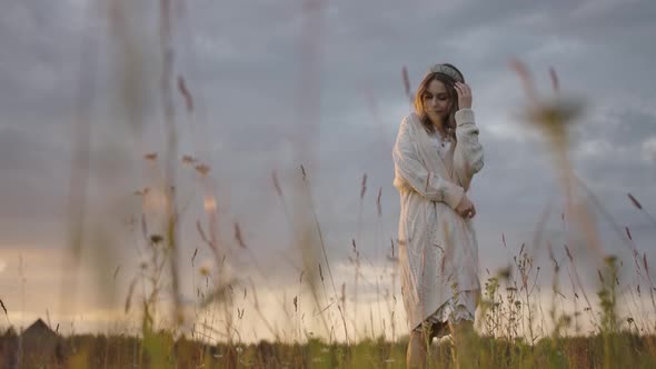 Graceful Lady Walking in Rural Grassy Field