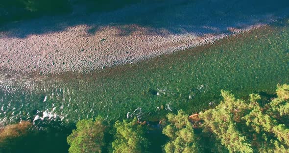 Low Altitude Flight Over Fresh Fast Mountain River with Rocks at Sunny Summer Morning