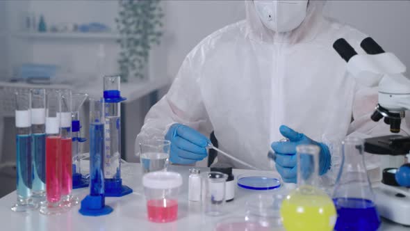 Medical Research in Laboratory Male Scientific Worker is Mixing Liquids in Petri Dish