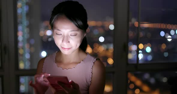 Woman working on cellphone at night 