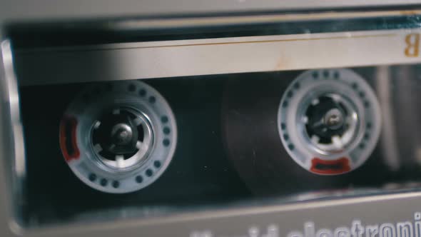 Audio Cassette Is Inserted Into the Deck of the Audio Tape Recorder Playing and Rotates