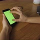 Holding And Using Mobile Phone With Green Sceen - VideoHive Item for Sale