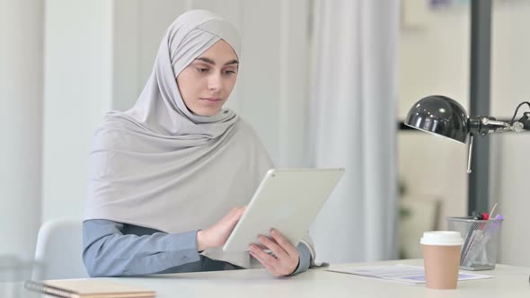 Attractive Young Arab Woman Using Tablet in Office