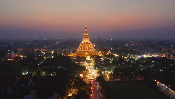 Aerial top view of Phra Pathommachedi temple at night.
