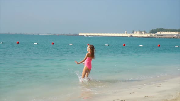 Happy Girl Enjoy Summer Vacation on the Beach