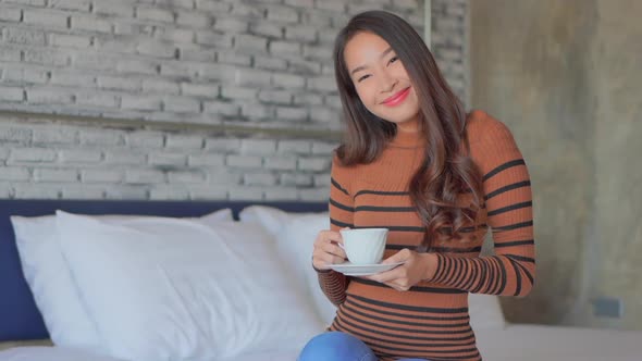 Young asian woman with coffee cup