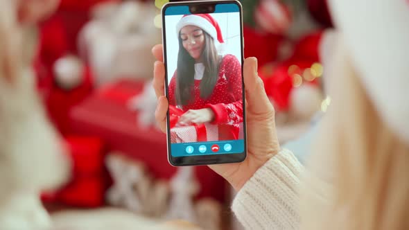 Happy Senior Grandparents Greeting Grandchild Open Christmas Gift on Video Call