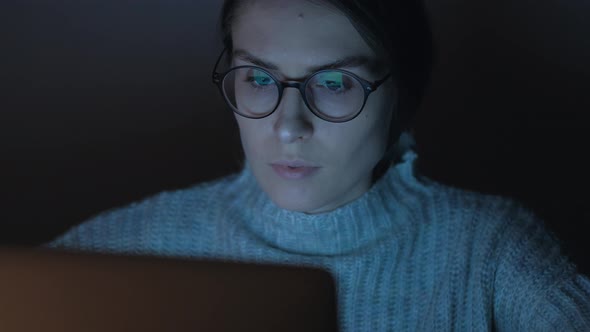 Portrait of a Female Working at the Computer at Night