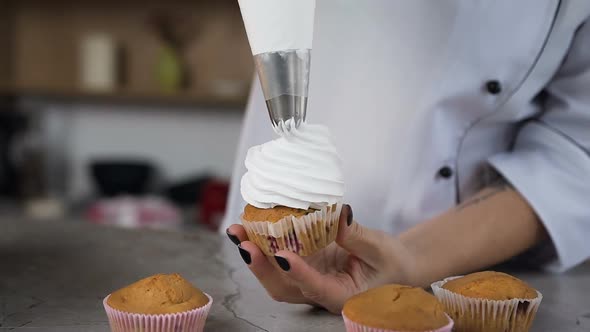 Chef Using Pastry Bag to Putting Cream on the Cake