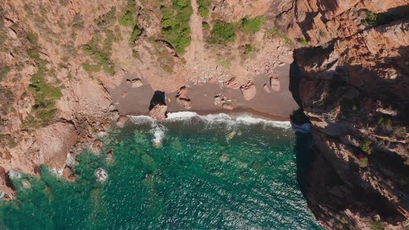 Aerial Top View of Red Sand Beach Waves Crushing on the Beach