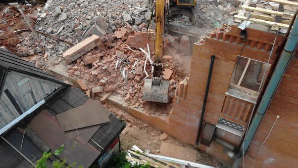 Excavator Digs Rubbles of Abandoned Cottage at District alt